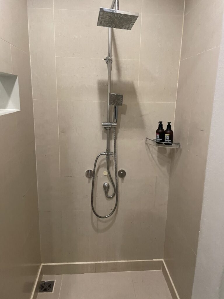 Walk-in shower with rainfall head and handheld sprayer at Metadee Concept Hotel Phuket