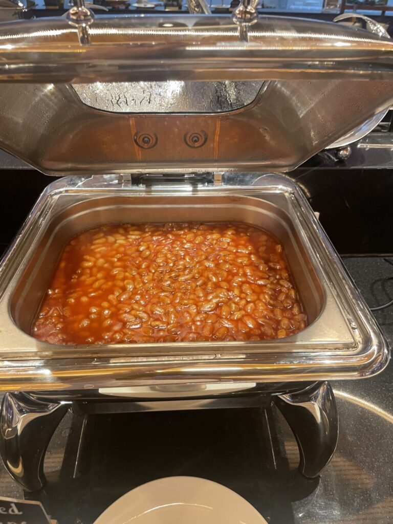 Chafing dish with baked beans in tomato sauce.