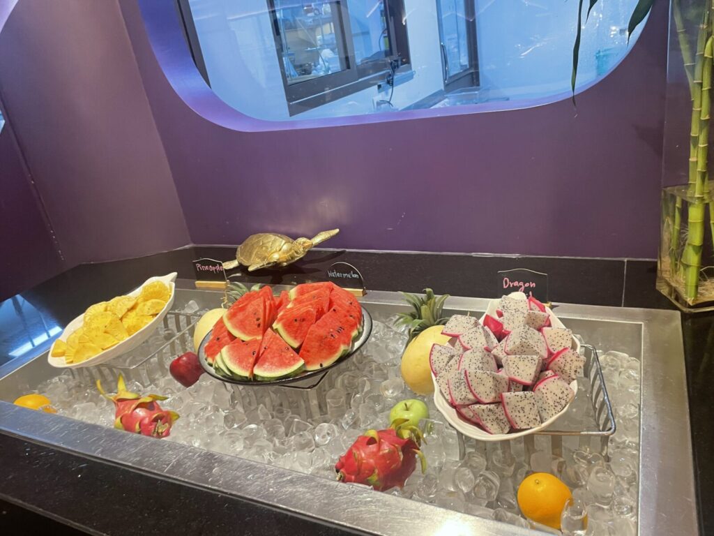 Fruit station on ice with sliced watermelon and dragon fruit cubes.